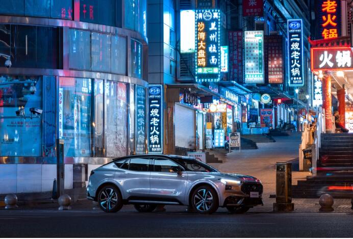 A car parked in front of a building with neon signsDescription automatically generated with medium confidence